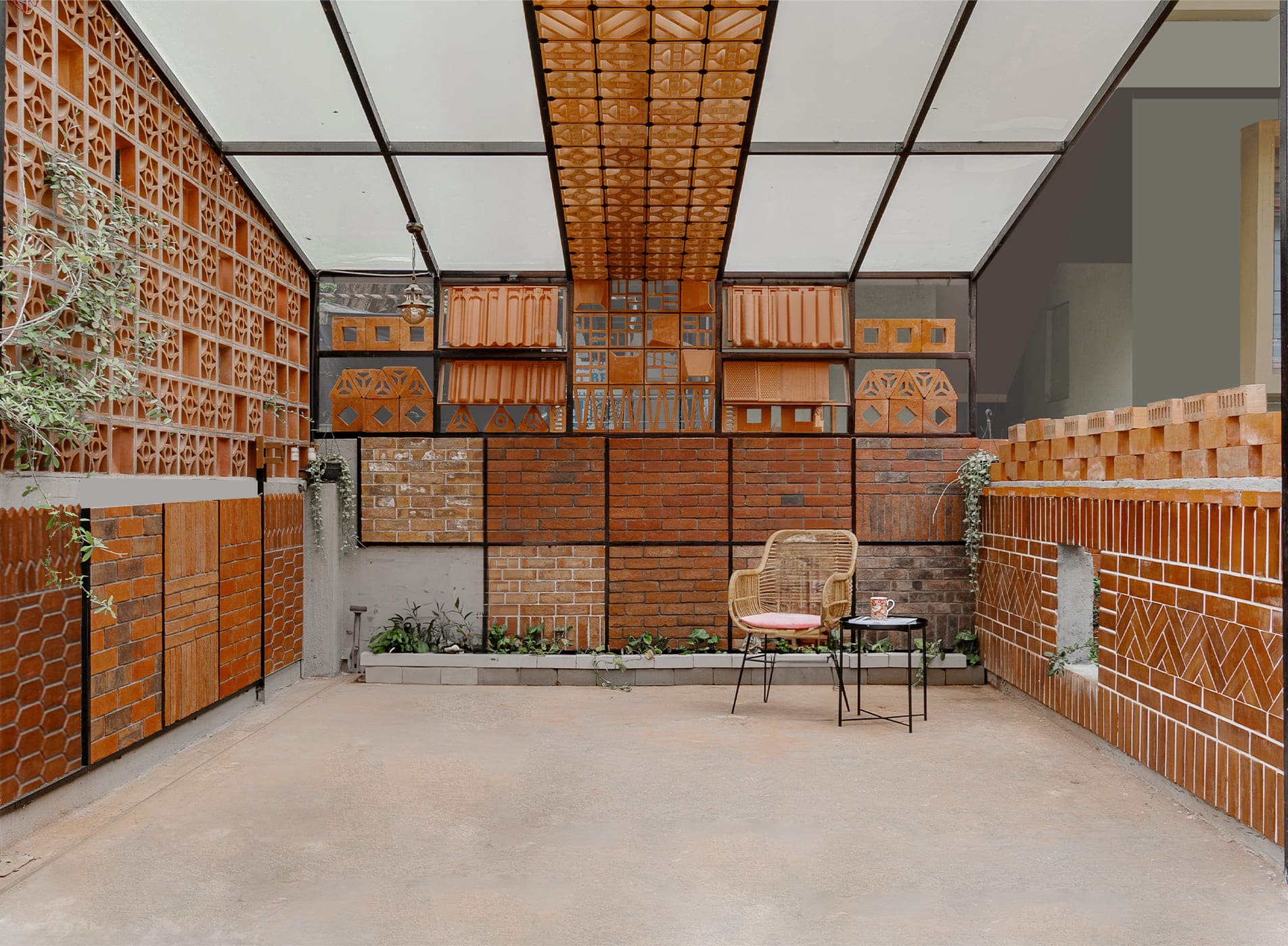 Terracotta clay jali and brick wall designs in a modern architectural interior space.