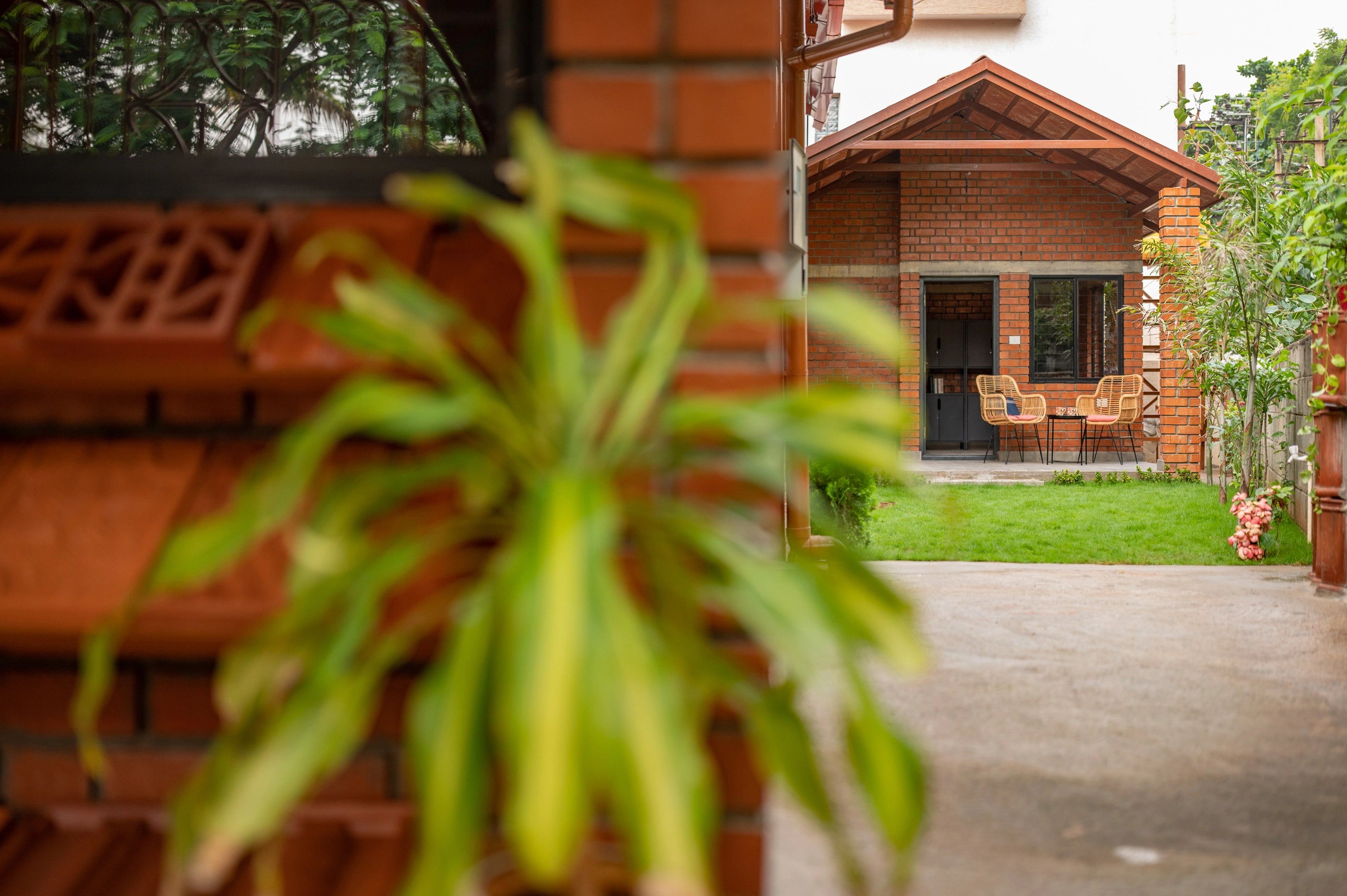 Brick building with outdoor seating area and greenery
