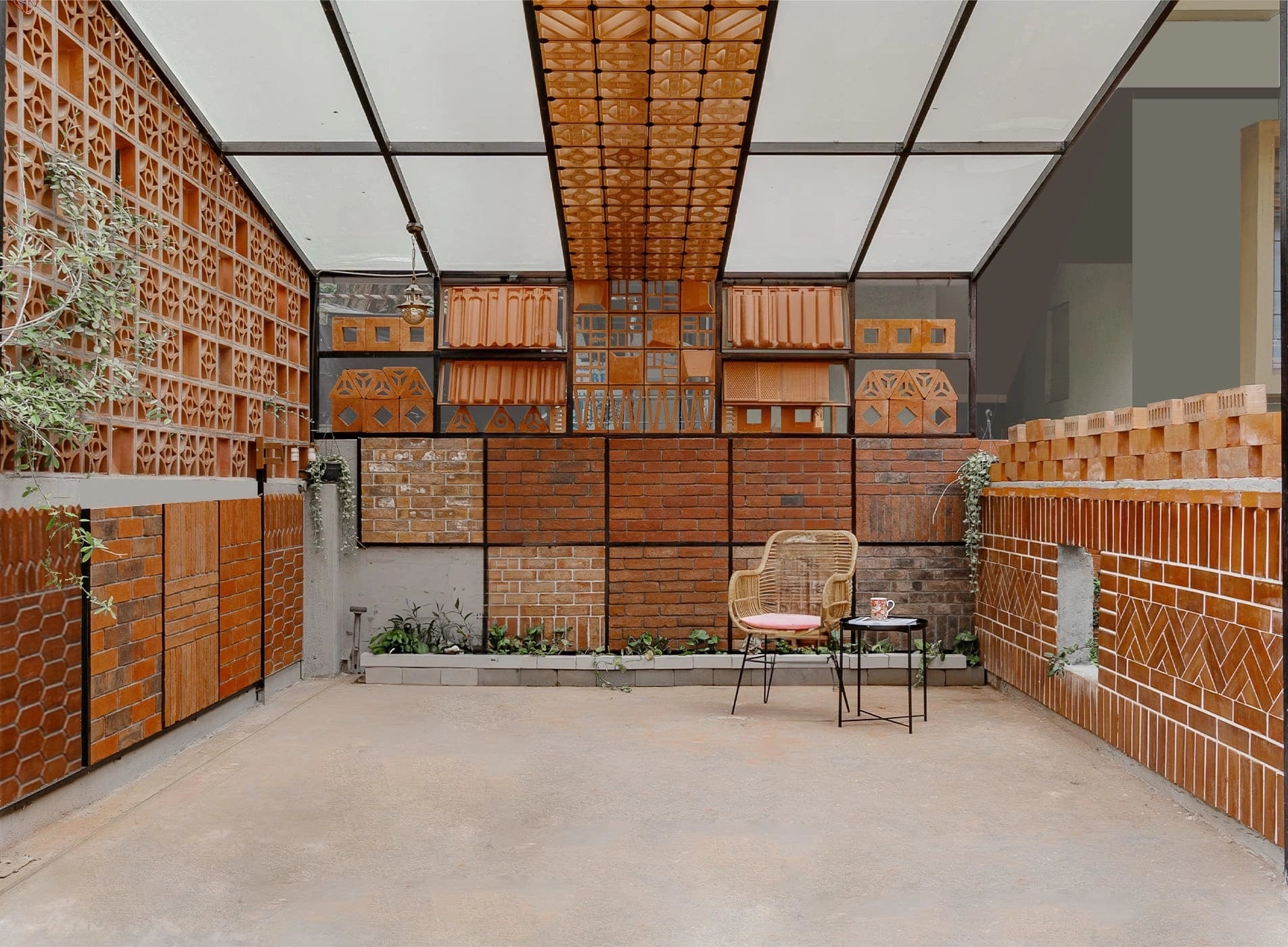 Modern indoor space with brick walls and ceiling, featuring a chair and small table.